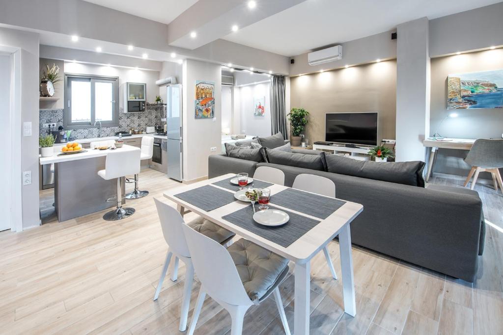 a living room and kitchen with a table and a couch at Super Loft With Acropolis View in Athens