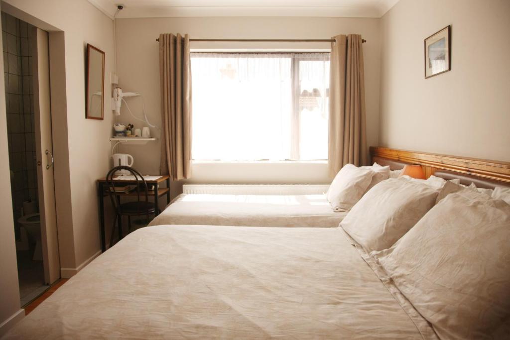 Postel nebo postele na pokoji v ubytování Torine House B&B