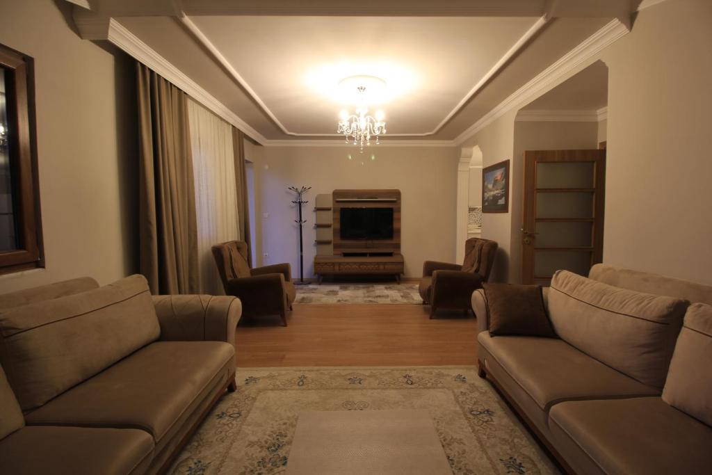 a living room with two couches and a television at Koç Motel in Uzungöl