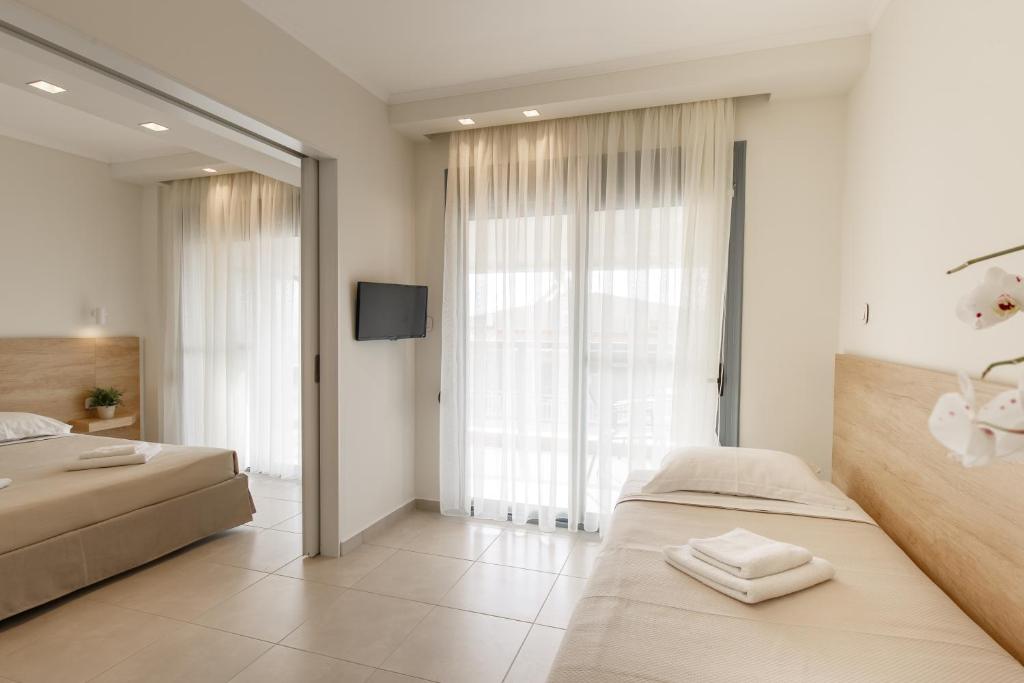 Postel nebo postele na pokoji v ubytování Marialena Hotel