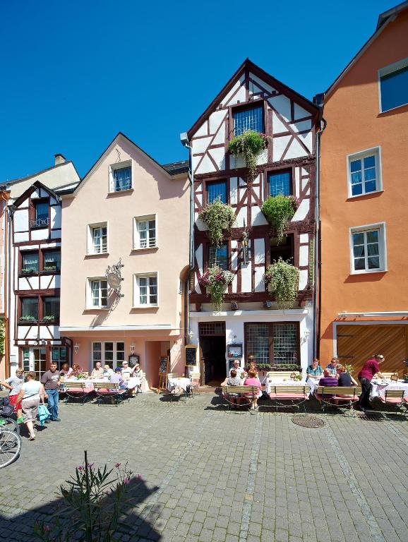 a group of people sitting outside of a building at Gästehaus am Schlossberg in Bernkastel-Kues