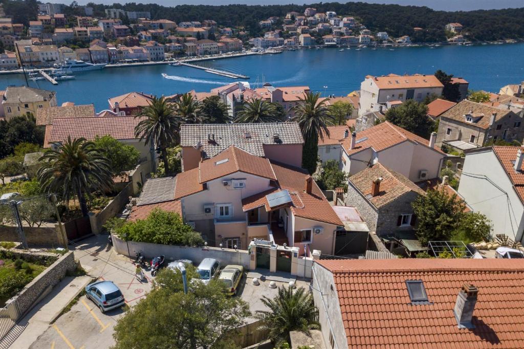 a view of a town with a river and buildings at Apartments Goga in Mali Lošinj