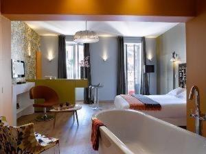 uma casa de banho com uma cama e uma banheira num quarto em "Un Lieu Unique" Le Lodge et le Dolce em Annecy