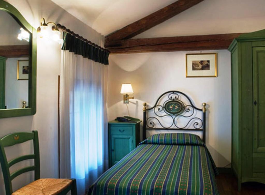 Кровать или кровати в номере Albergo La Bersagliera