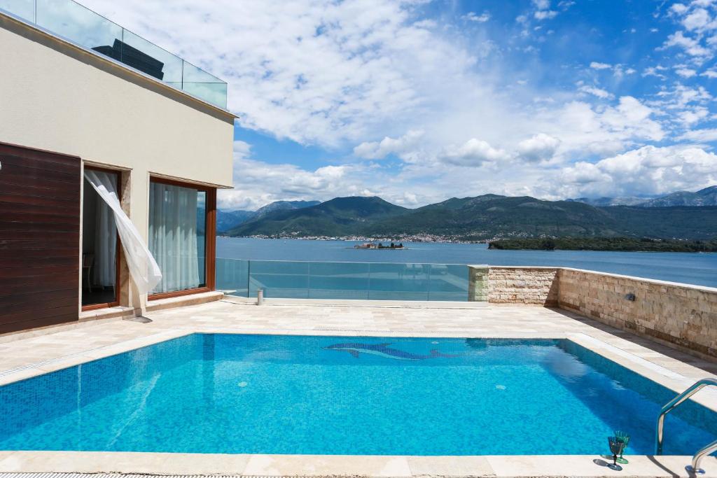 a swimming pool with a view of the water at Villa Semiramis in Tivat