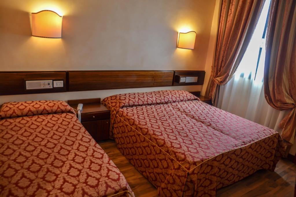 Postel nebo postele na pokoji v ubytování Hotel Le Boulevard