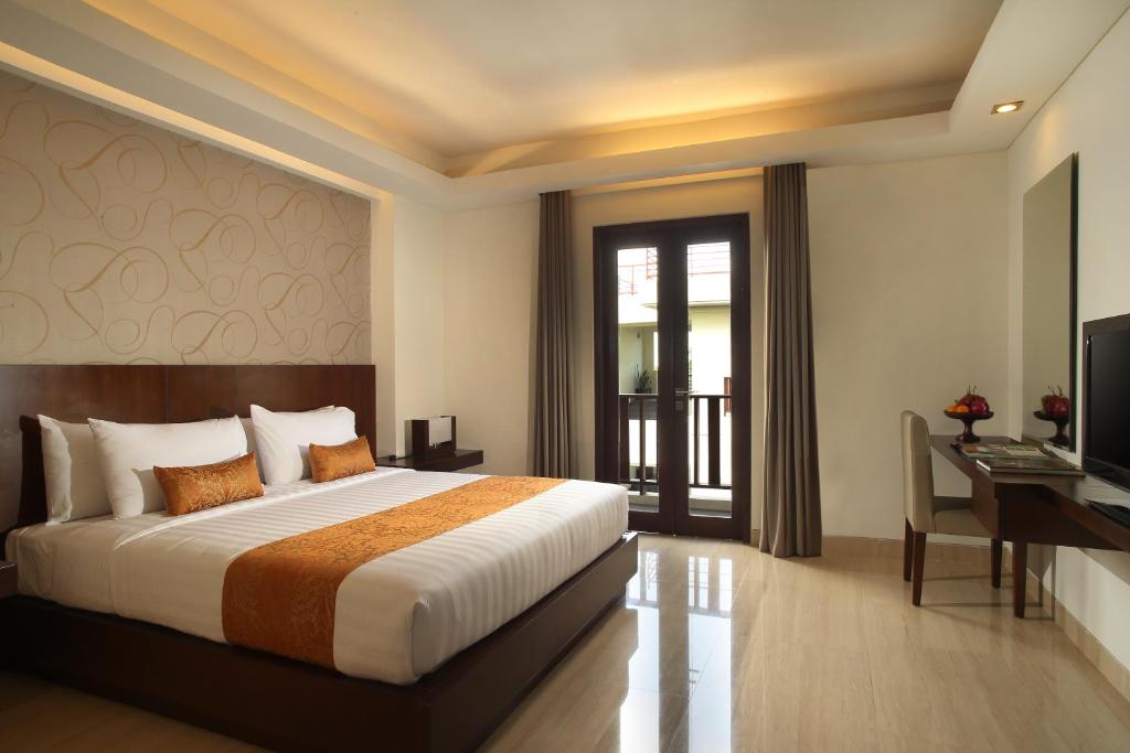 Postel nebo postele na pokoji v ubytování d'primahotel Seminyak