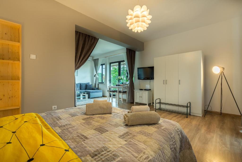 een slaapkamer met een groot bed en een woonkamer bij Studio Andrea in Rovinj