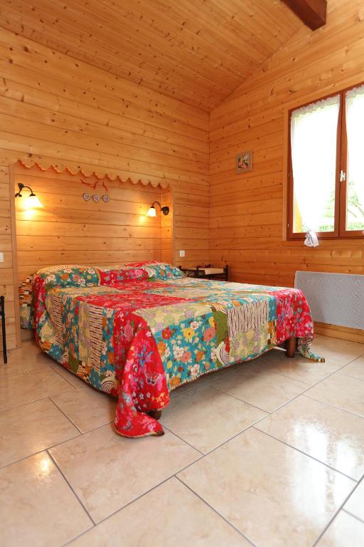 a bedroom with a bed in a wooden room at Chalet de Grettery in Saulxures-sur-Moselotte