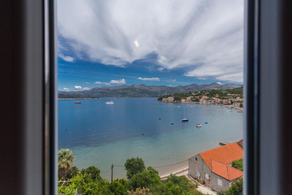 a view of a beach with boats in the water at New apartment with terrace and sea view in Lopud Island