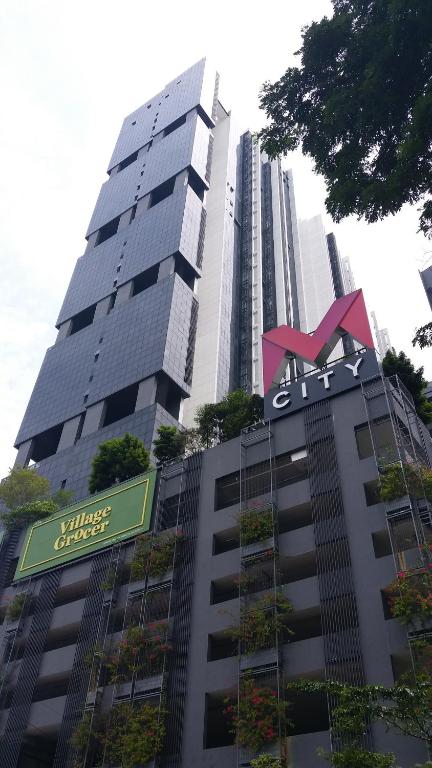 a tall building with a sign on top of it at M City Center Jalan Ampang Lakeview KLCC KL Tower Merdeka 118 TRX View in Kuala Lumpur
