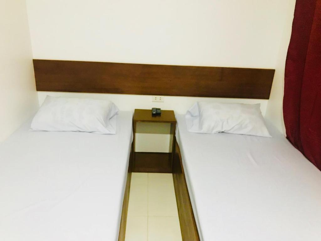 Postel nebo postele na pokoji v ubytování Greenfields Tourist Inn
