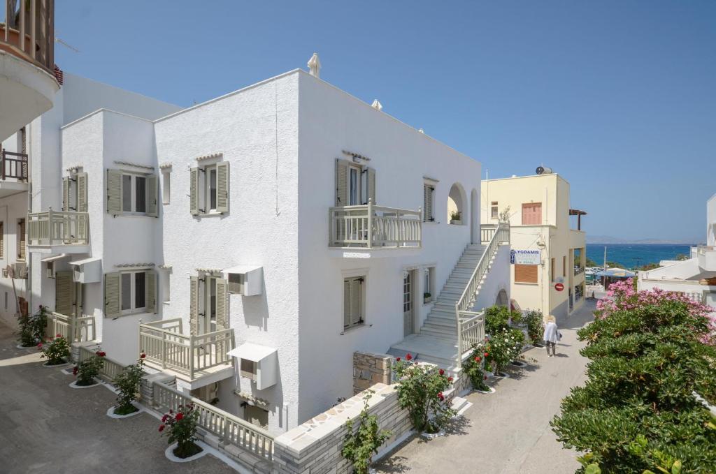 a large white building with a white house at Lygdamis Hotel in Naxos Chora