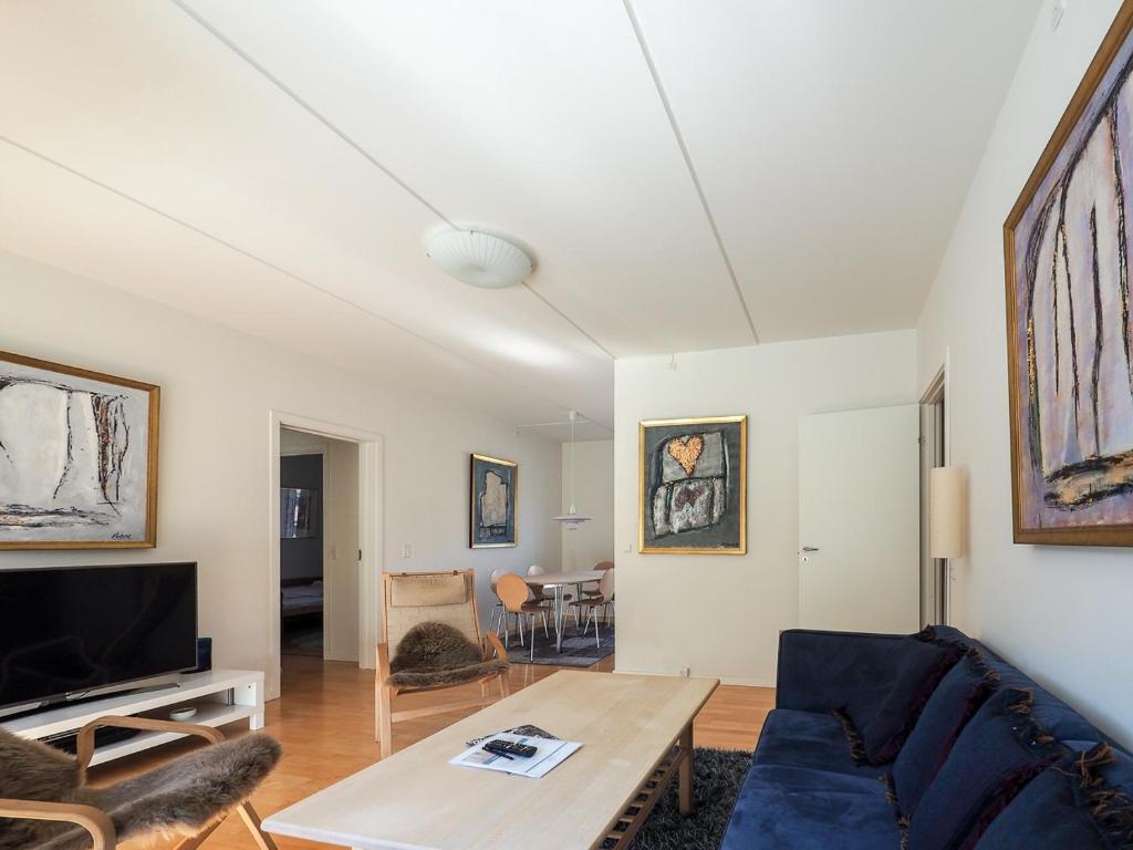 a living room with a couch and a table at Modern city centre flat by Tivoli Gardens in Copenhagen