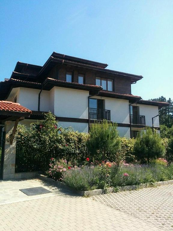 a large house with a garden in front of it at Limani Guest house in Sozopol