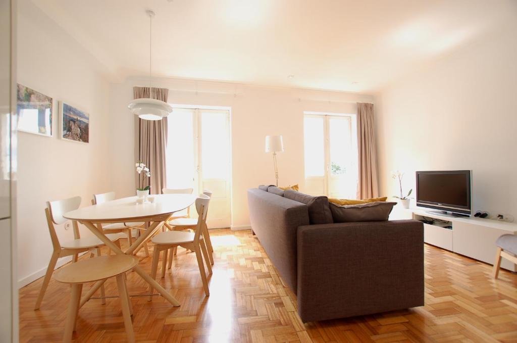a living room with a couch and a table at Downtown Cathedral Apartment in Braga