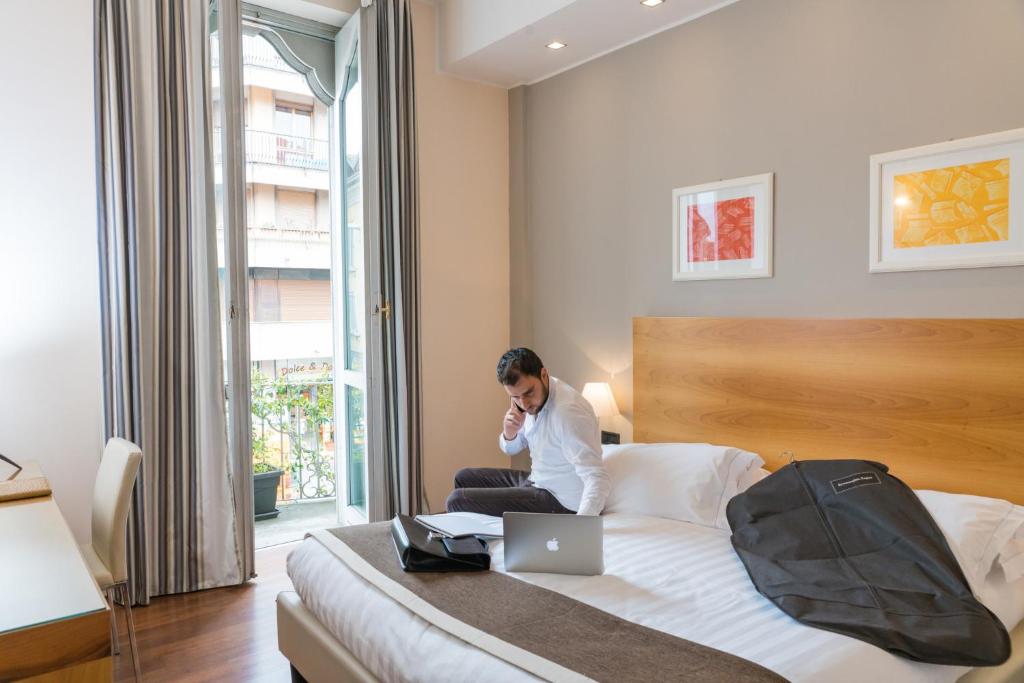 Postel nebo postele na pokoji v ubytování Hotel Royal Falcone