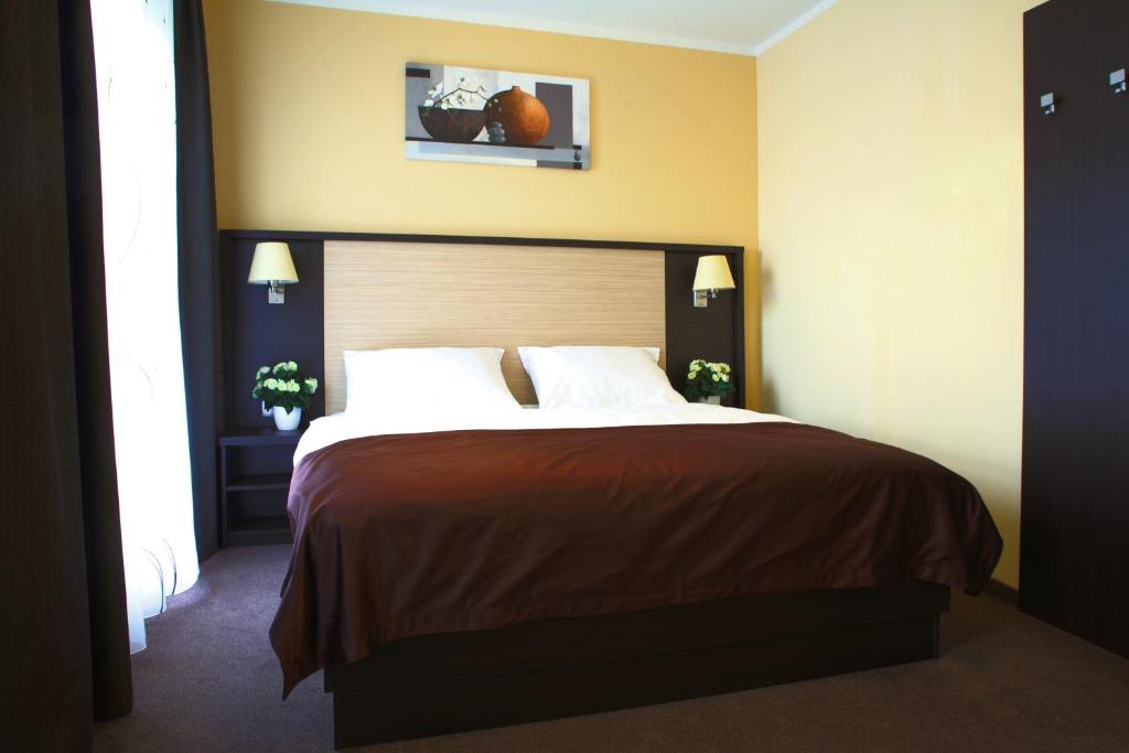 Postel nebo postele na pokoji v ubytování Casino & Hotel ADMIRAL Ptuj