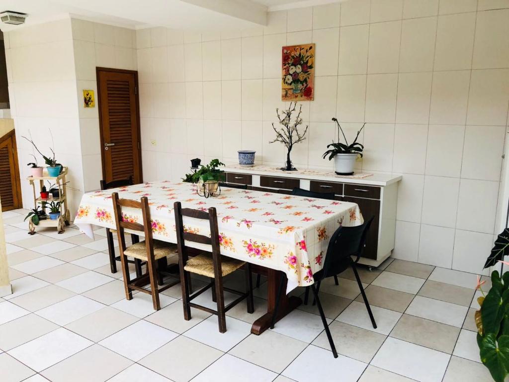 a kitchen with a table and chairs in a room at Hospedagem Granville in São Paulo