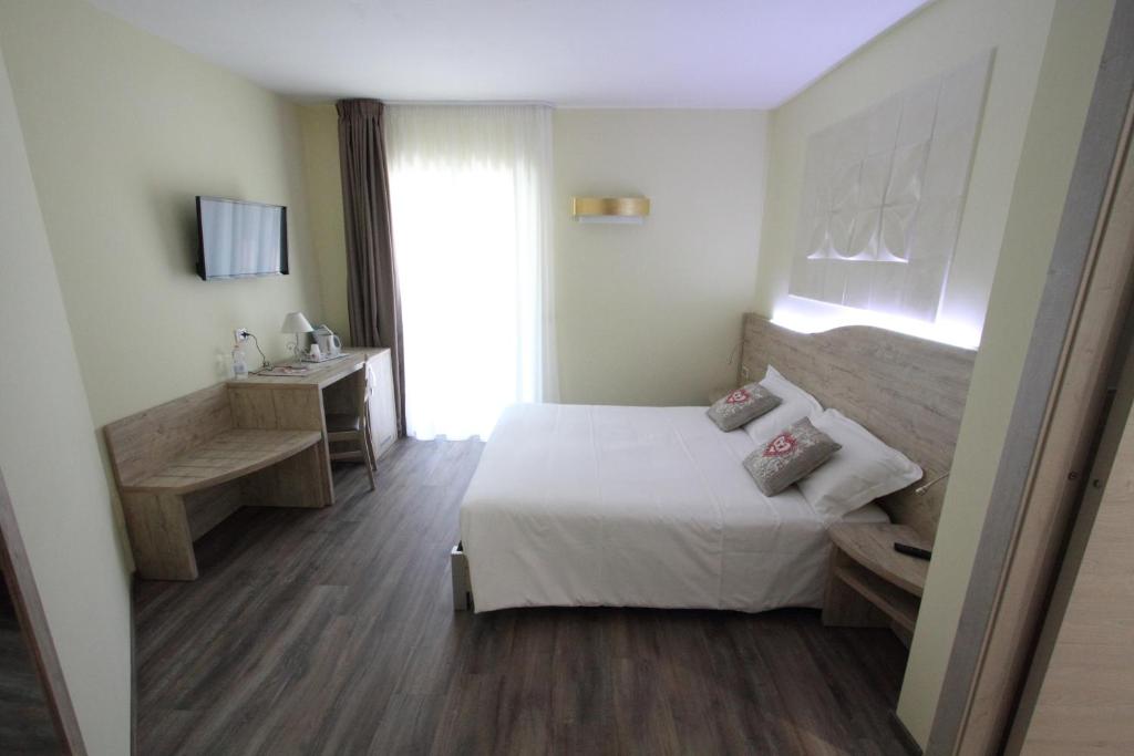 a bedroom with a bed and a desk and a television at "Il Viottolo" Rooms in Roccaraso
