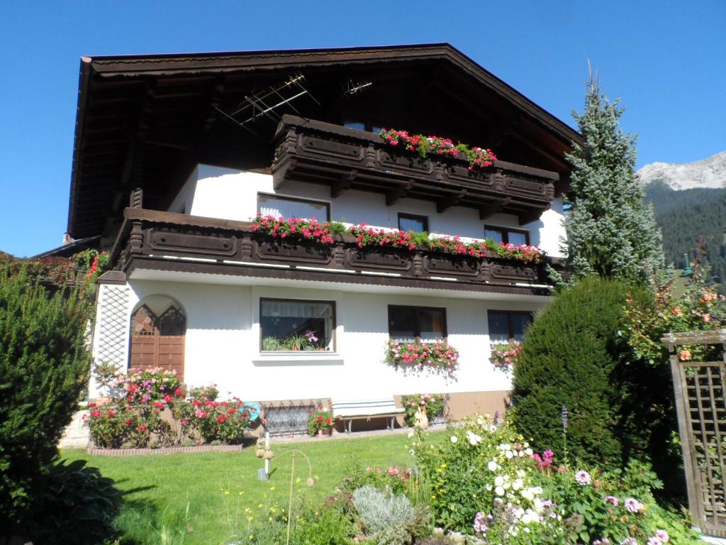 a house with flower boxes on the windows at Jogglerhaus in Lermoos
