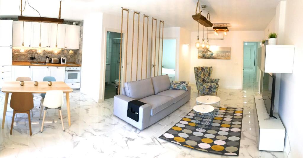 a living room with a couch and a table at New central 2BR apartment 100m-to-beach free parking in Fuengirola