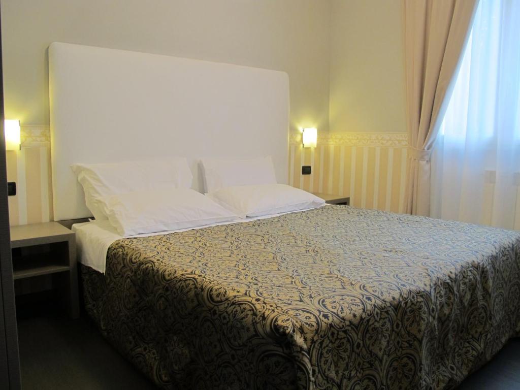Postel nebo postele na pokoji v ubytování Hotel Laguna Residence