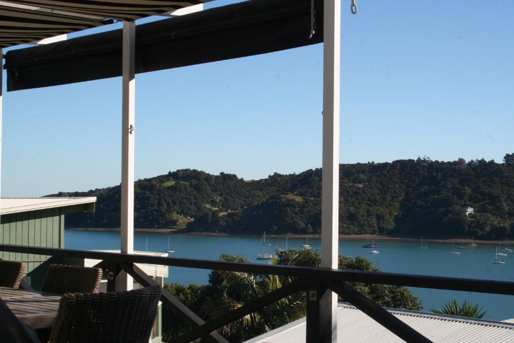 a view of the water from the balcony of a house at Black Bach on Burrell in Oneroa