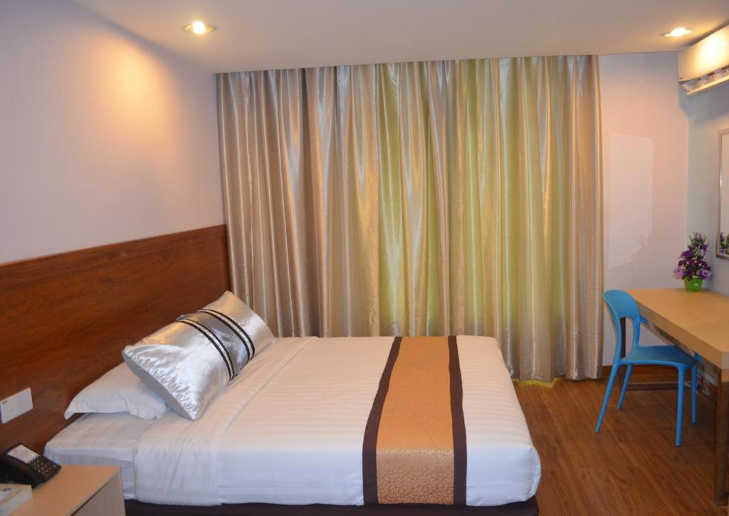 Postel nebo postele na pokoji v ubytování TD Mutiara Hotel Semporna