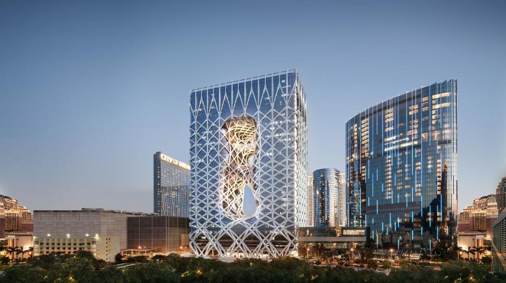 a large building with a large clock on the side of it at City of Dreams - Morpheus in Macau