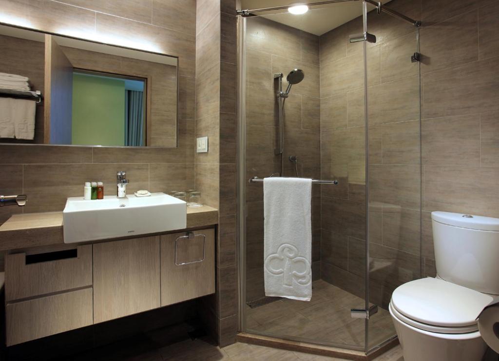 a bathroom with a toilet and a sink and a shower at Park City Hotel - Luzhou Taipei in Taipei