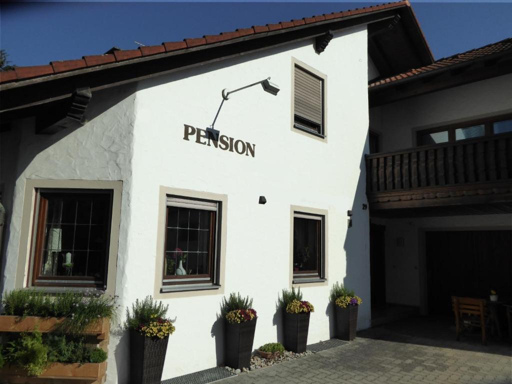 a white building with a sign that reads permission at Haus Rosmarin in Schrobenhausen