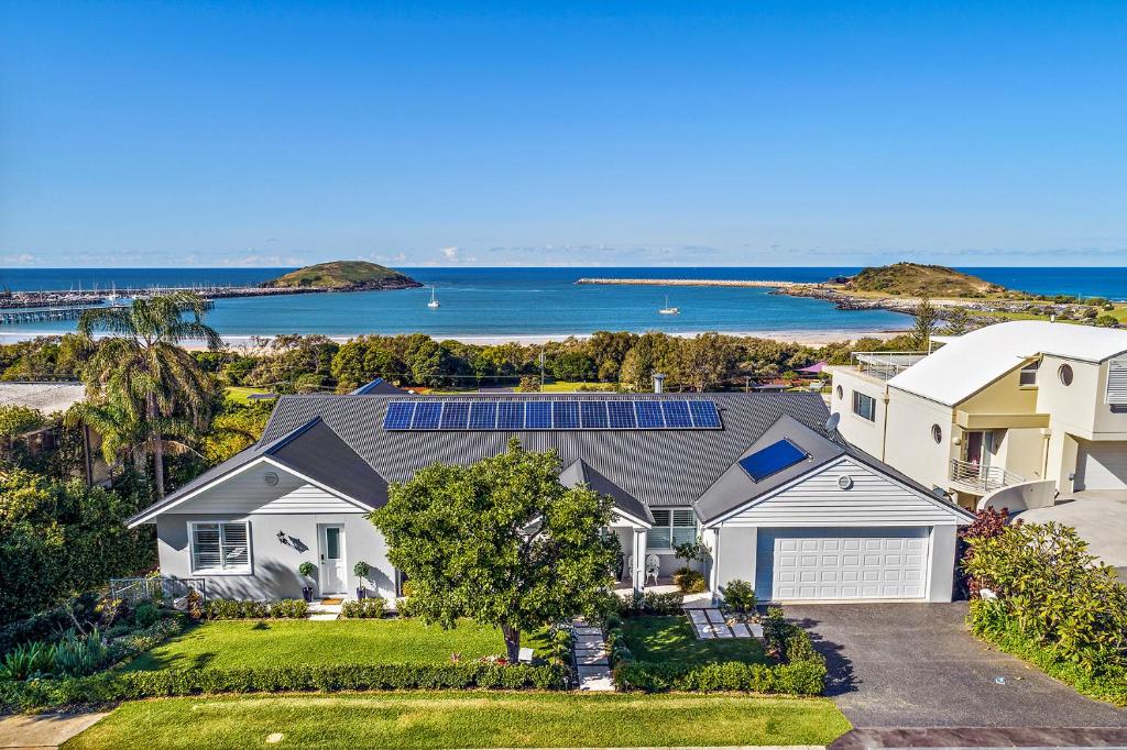 una vista aérea de una casa con paneles solares en el techo en Jetty Beach Splendour Apartment en Coffs Harbour