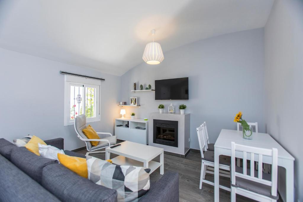 a living room with a couch and a table at Casa Alma in Marbella