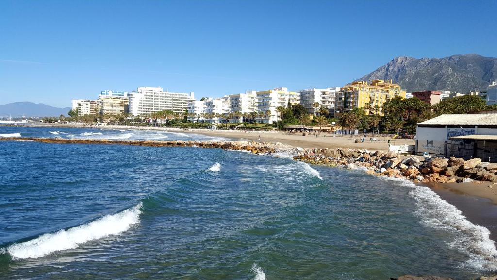 a view of a beach with buildings in the background at Casa Alma in Marbella