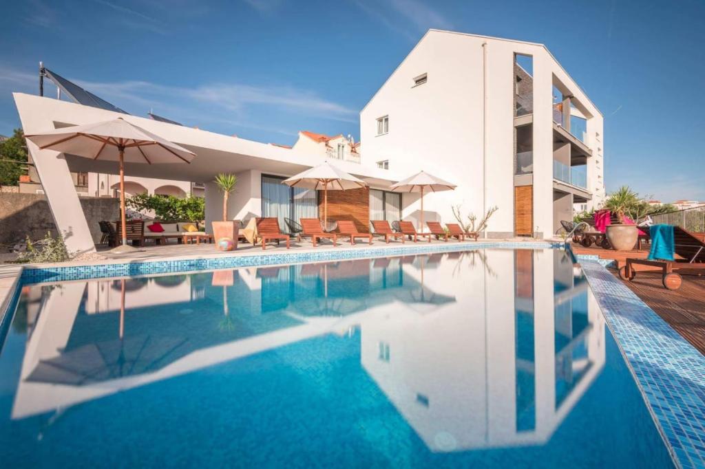 a swimming pool in front of a house at Residence Delta in Cavtat