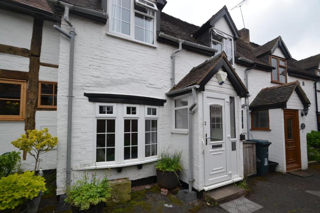 a white house with a white door at Abbey Cottage in Shrewsbury