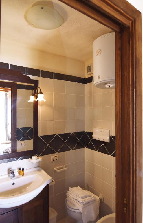 a bathroom with a sink and a toilet at Bella Baia Relais in Maiori