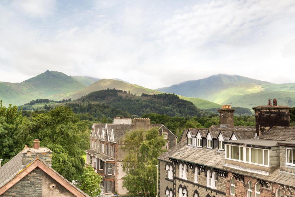 a group of buildings with mountains in the background at Balmoral Apartment in Keswick