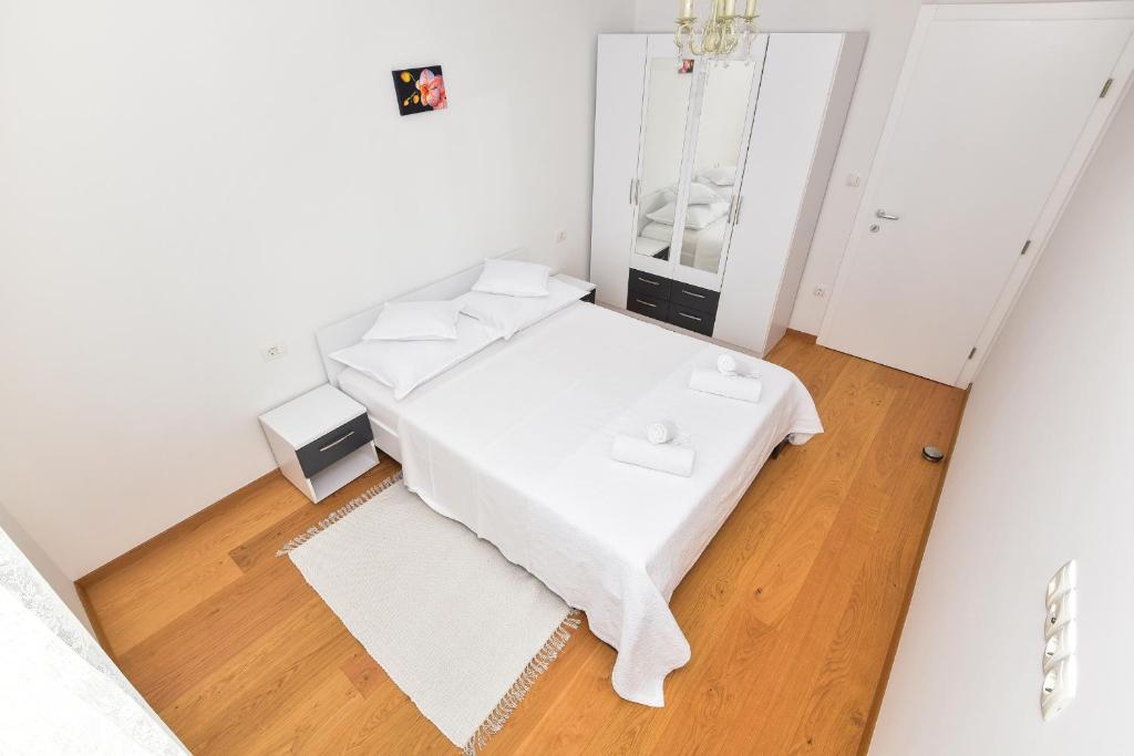 Postel nebo postele na pokoji v ubytování Apartments Evelin