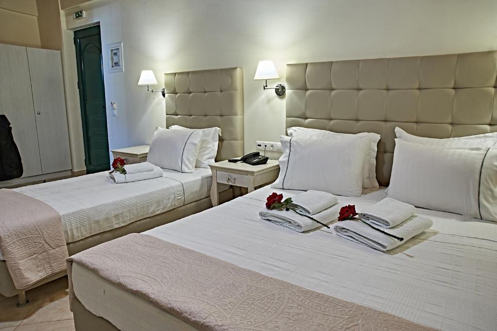 a hotel room with two beds with flowers on them at Element Hotel in Elafonisos