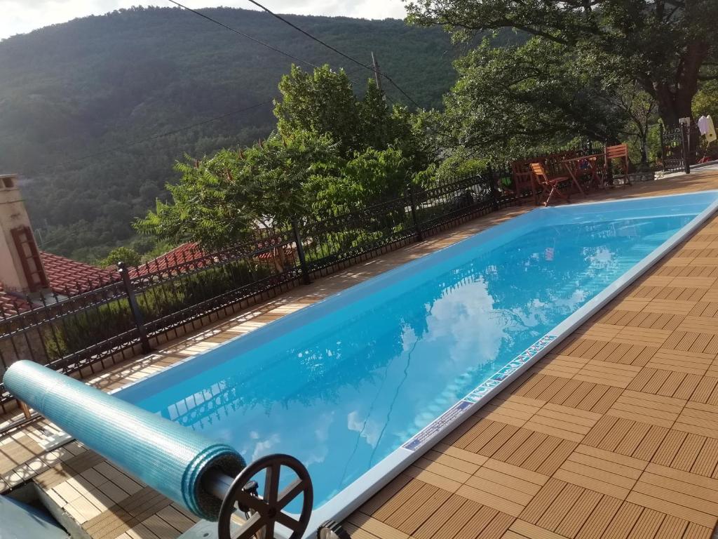 a swimming pool with a mountain in the background at Holiday Homes Mirjana in Mošćenička Draga