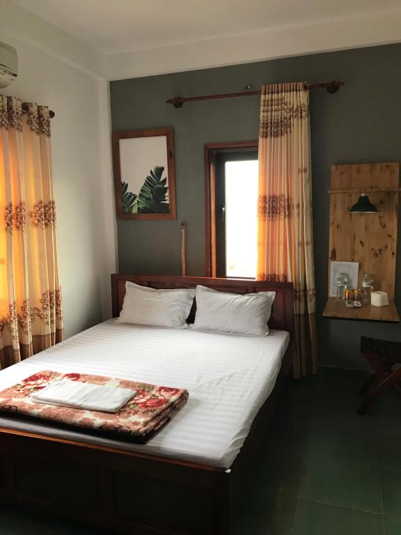 a bedroom with a bed with a tray on it at Thao Trang Hotel in Dong Hoi