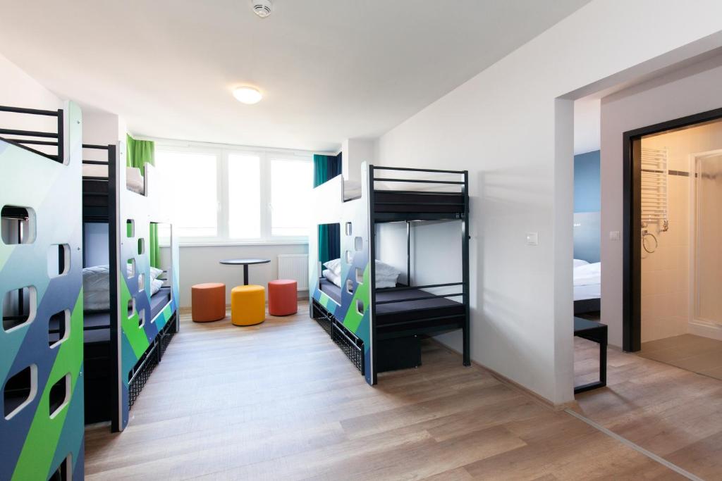 a room with bunk beds and a hallway at a&o Prague Rhea in Prague