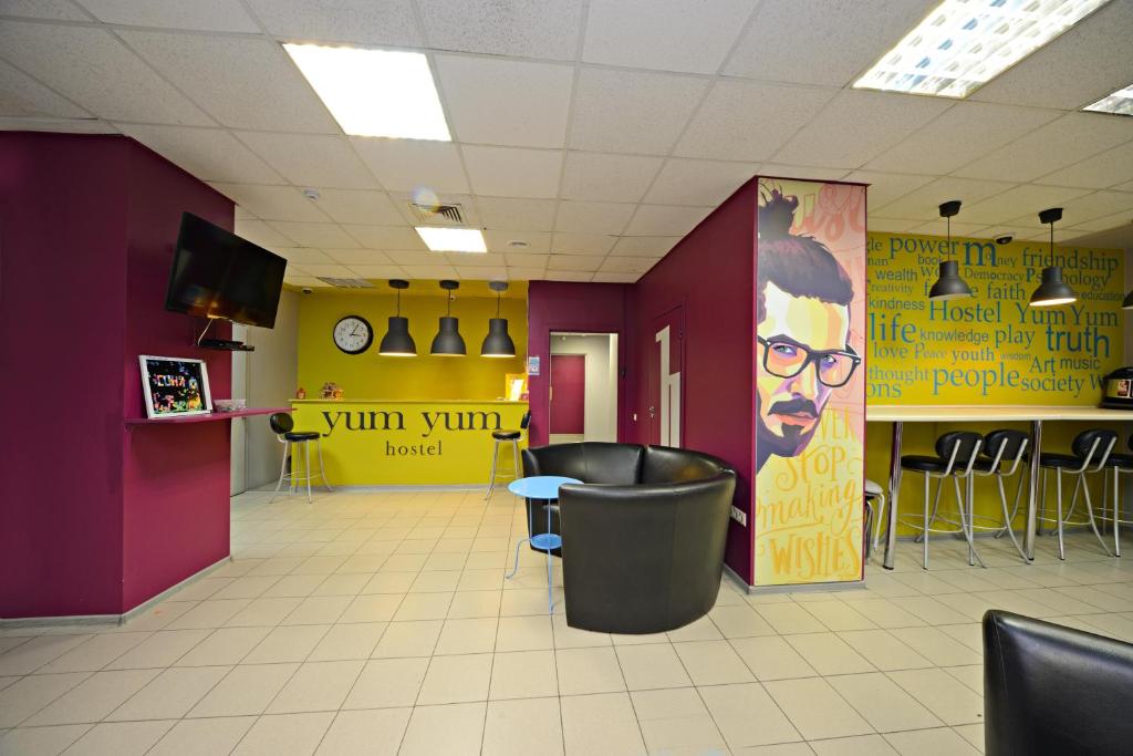 a waiting room with purple and yellow walls and chairs at Yum-Yum Hostel in Moscow