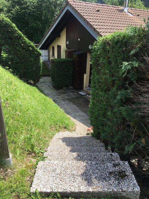 une maison avec une passerelle devant une cour dans l'établissement Résidence Vologne, à La Bresse