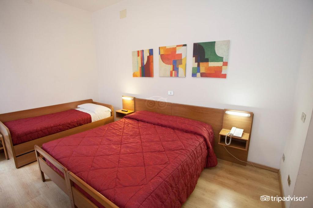 Postel nebo postele na pokoji v ubytování Hotel Caprera