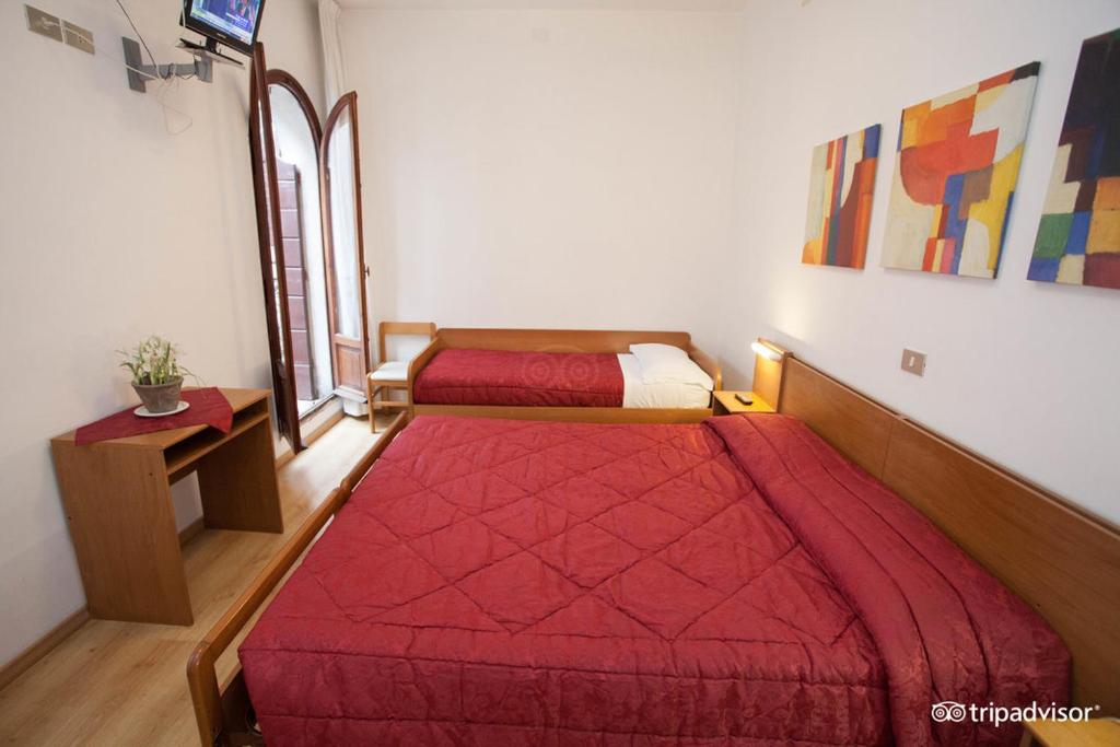 Postel nebo postele na pokoji v ubytování Hotel Caprera