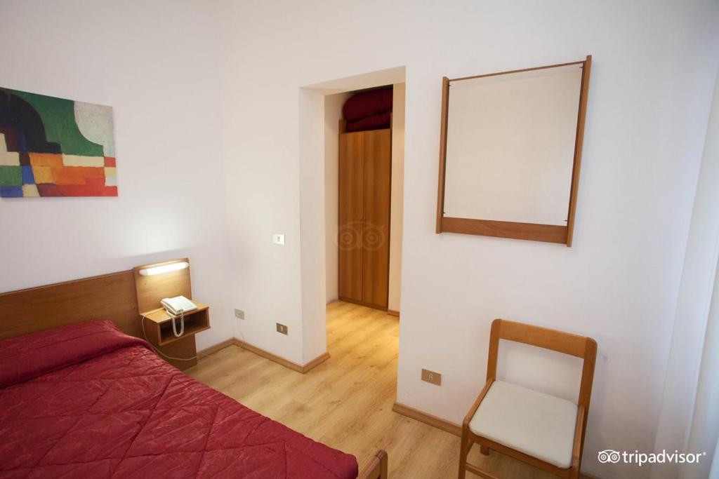 Postel nebo postele na pokoji v ubytování Hotel Caprera