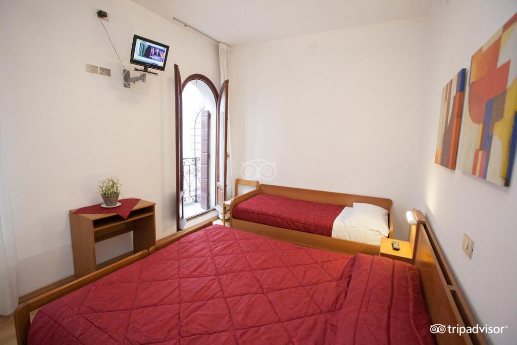 Postel nebo postele na pokoji v ubytování Hotel Caprera